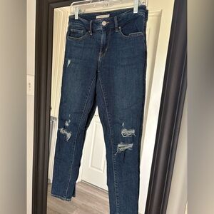 Levi’s 711 skinny women’s. Dark wash with teased ripped knees